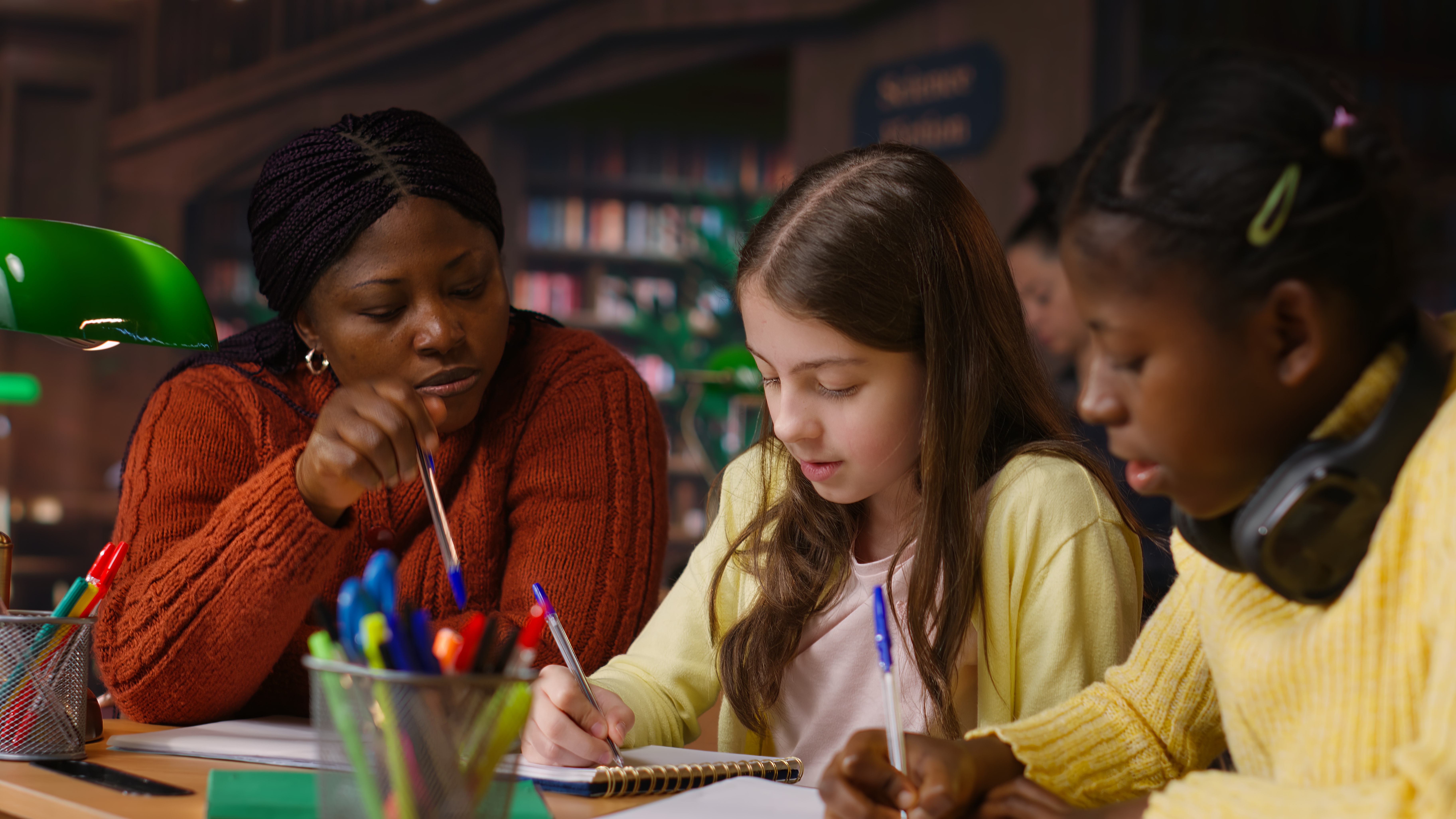Teacher assisting students with homework